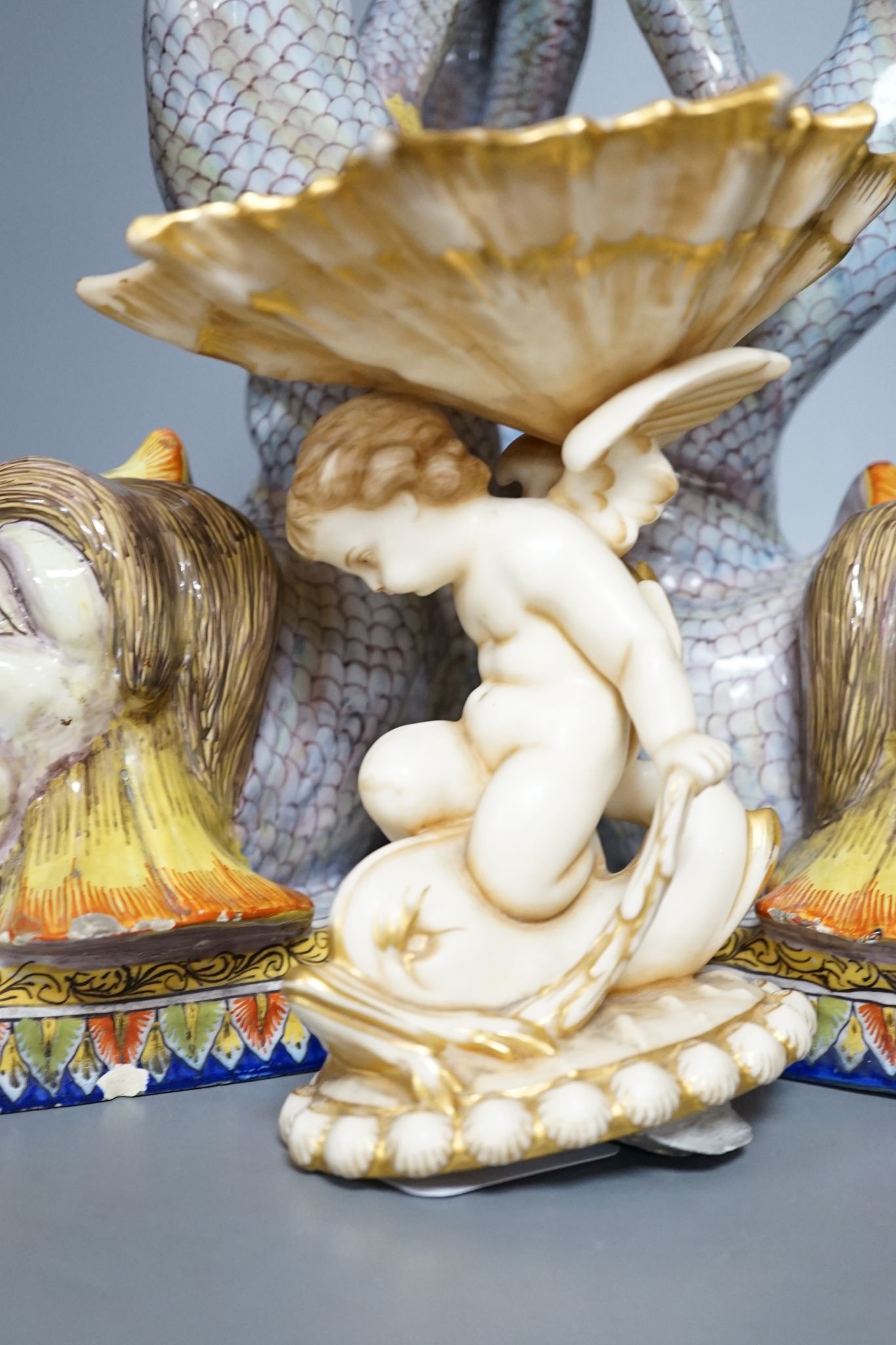 An 18th century Venetian maiolica ‘dolphin’ base and associated blush ivory cherubic figural bowl, 36cm